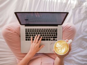 A person blogging from home to represent how to start a blog in South Africa.