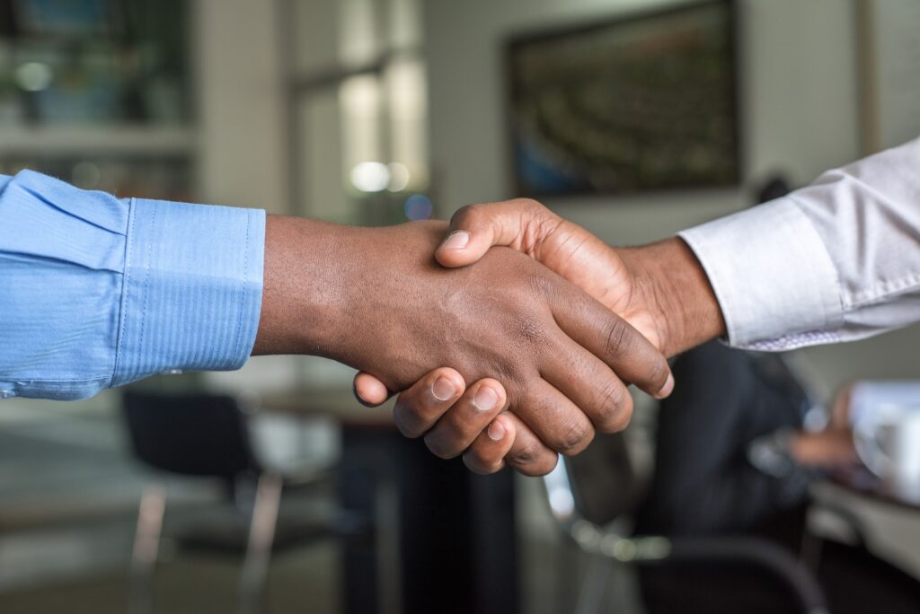 Men shaking hands at a networking event, one of the places to get leads.